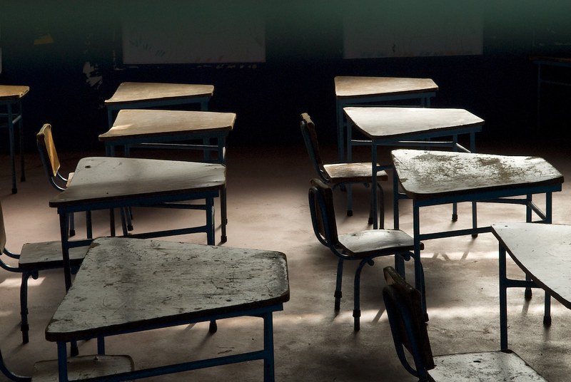 Empty desks lined up in a classroom